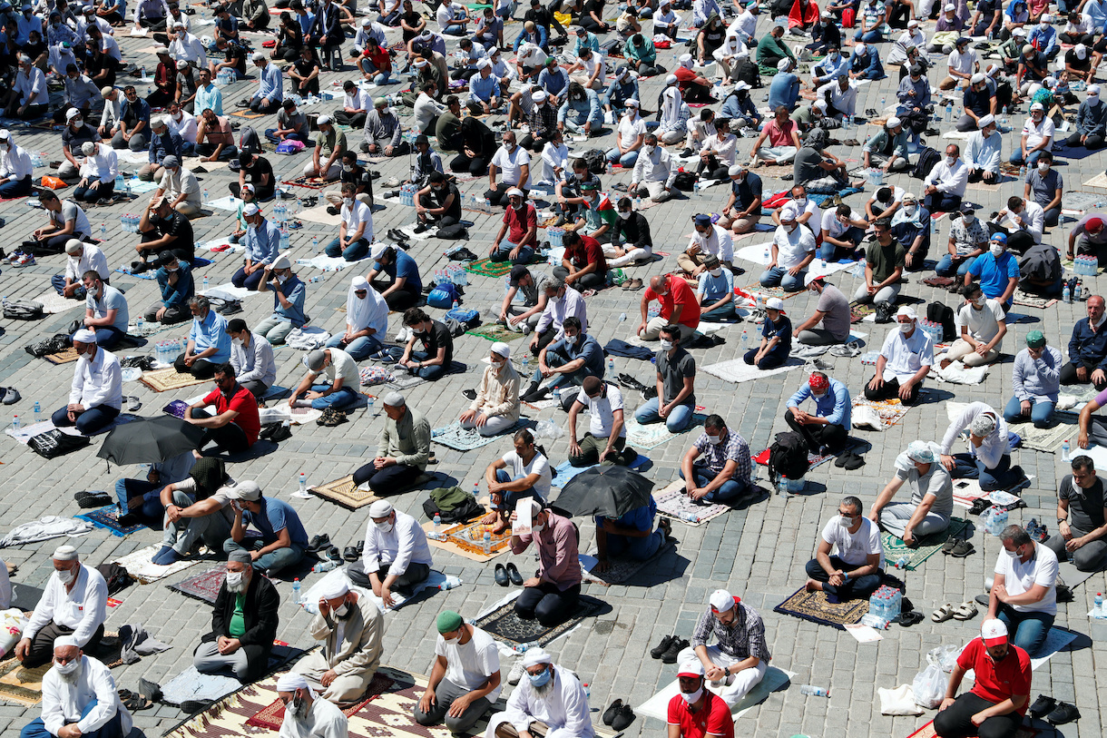 Muslims attend Friday prayers while practicing social distancing outside Hagia Sophia Grand Mosque, for the first time after it was once again declared a mosque after 86 years, in Istanbul, Turkey, July 24, 2020. REUTERS/Murad Sezer
