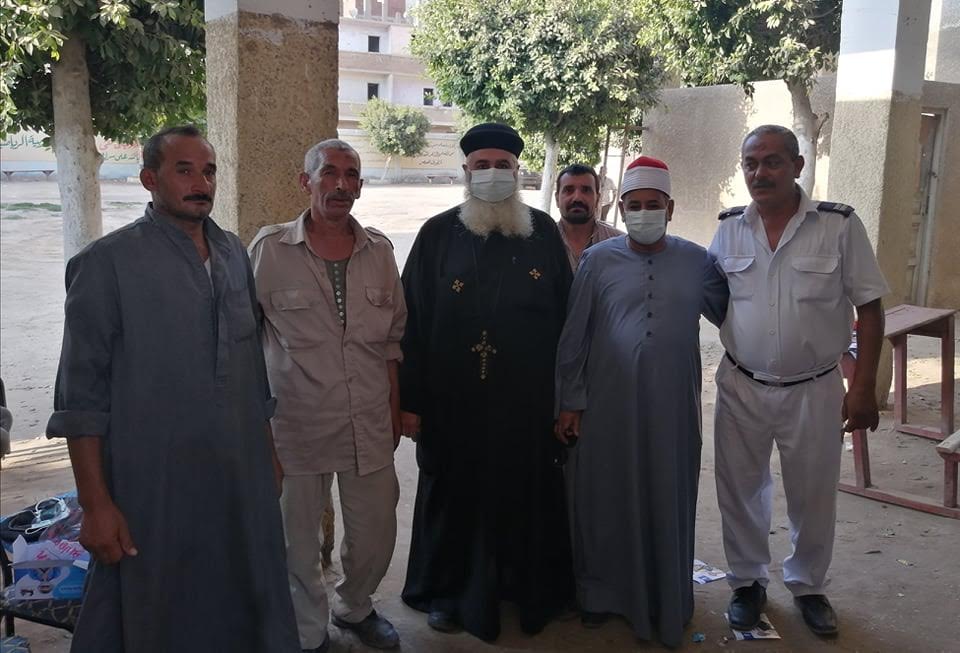 A Muslim imam and a Coptic priest are seen casting at a the same polling station in Sharqia, where a high turnout was recorded.