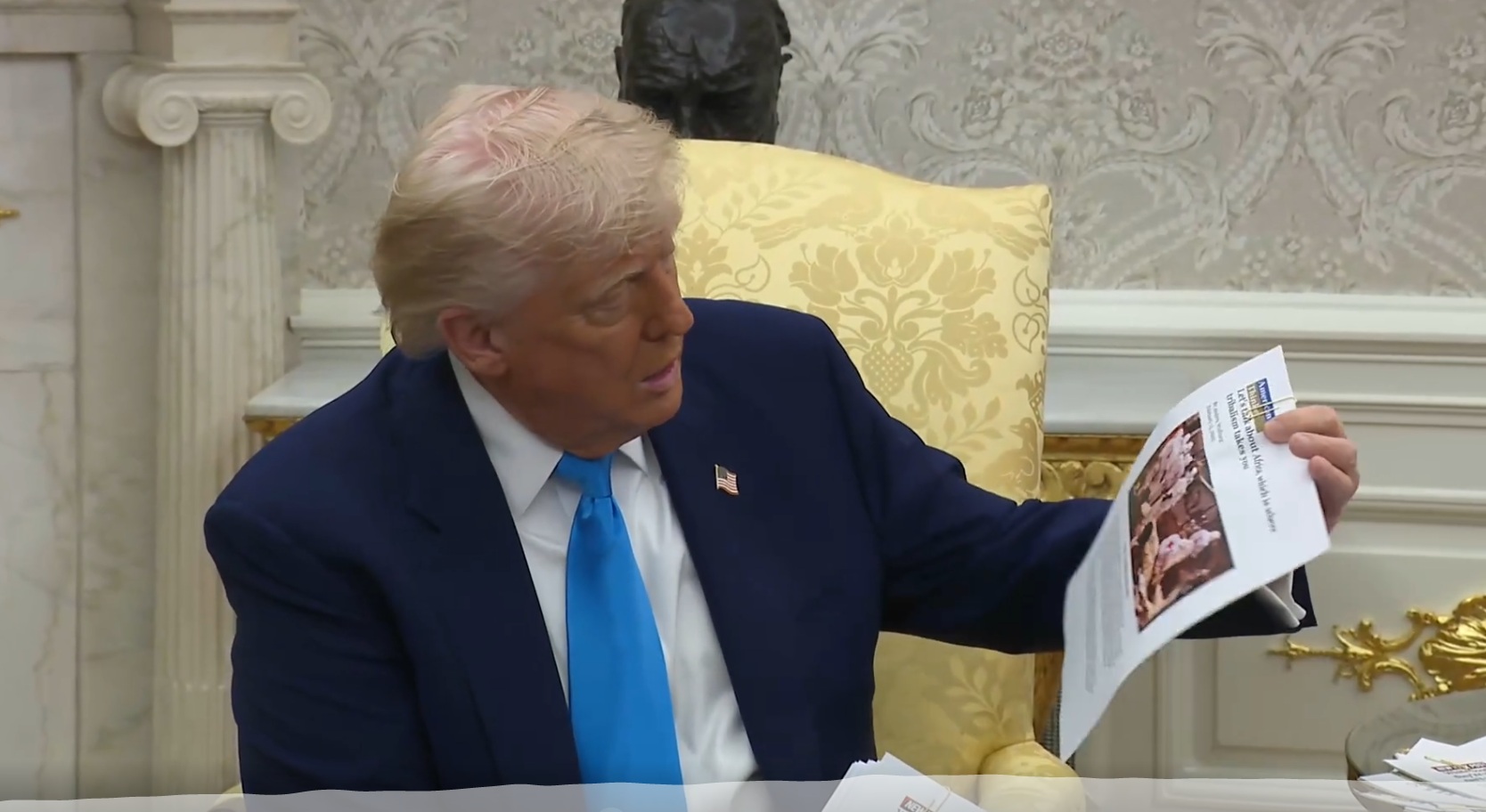 US President Donald Trump displays a screenshot from a Reuters video taken in the DR Congo, falsely claiming it shows mass killings of white farmers in South Africa US President Donald Trump displays a screenshot from a Reuters video taken in the DR Congo, falsely claiming it shows mass killings of white farmers in South Africa