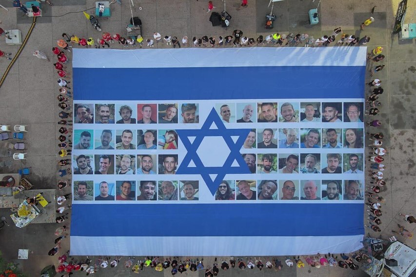 In the Hostage Square of Tel Aviv a giant Israeli flag adorned with portraits of the captives was displayed