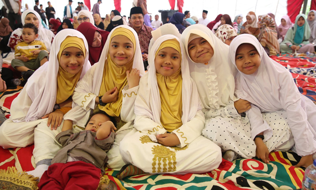 Indonesians pose for a picture during the celebration of Eid alFitr  at the embassy in Cairo- press photo